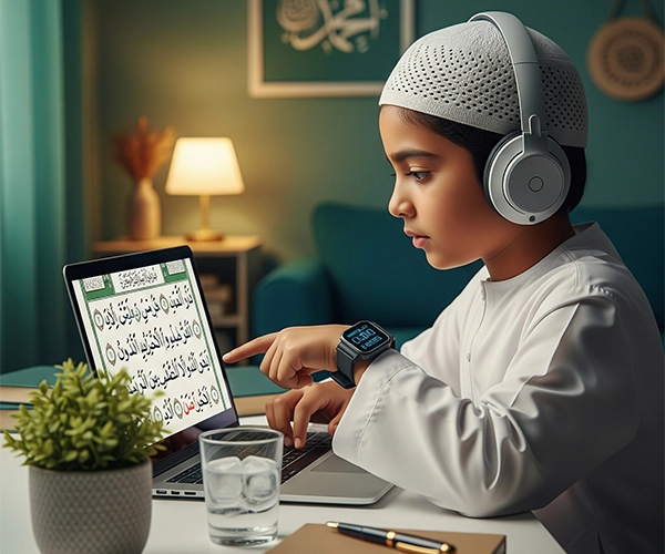 A young boy in a prayer cap and headphones, pointing at a Quranic verse on his laptop, representing the flexible scheduling of the Tajweed Course Online.